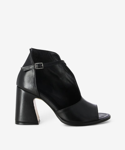 Black leather heel by ZOMP. It has a strap fastening and features a half open upper detail with a block heel and a soft square toe.