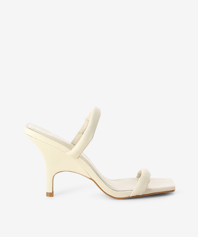 Off white leather heels by Sempre Di. It is a slip-on style and features dual padded straps, stiletto heel and a square toe.