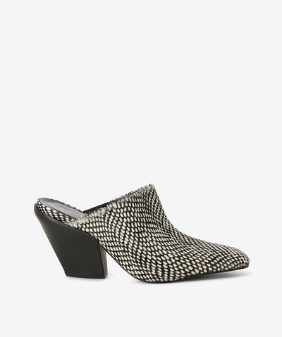 Black and white print pony hair leather mules by Sempre Di. It is a slip-on style and features a Cuban heel and a chisel toe.