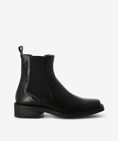 Black leather Chelsea boots with a slip-on style and features elastic gussets, pull tab, low heel and a square toe.