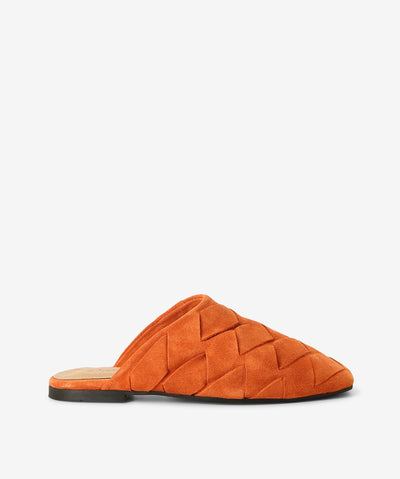 Orange suede mules by 2 Baia Vista. It is a slip-on style with an enclosed upper that features super soft interwoven suede as its upper, a flat sole, and a square toe. 