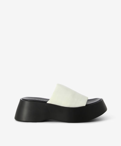 Black and White platform mules by 2 Baia Vista. It has a fabric and features a double-lined fabric upper and a squared toe.