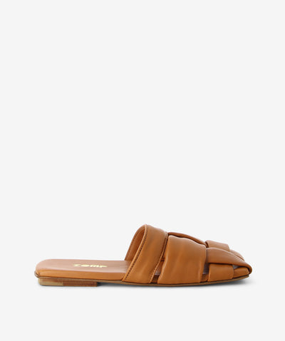 Tan leather slides by Zomp. It is a slip-on style and features a large open-weave upper, low heel and a semi-enclosed square toe.