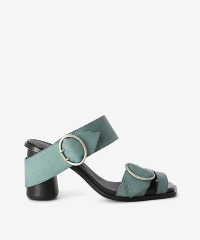 Green sage premium nappa leather heeled sandals by Beau Coops. It has an antique silver oval buckled strap with buckles with wrap around heel and features an oval block heel and a soft square toe.