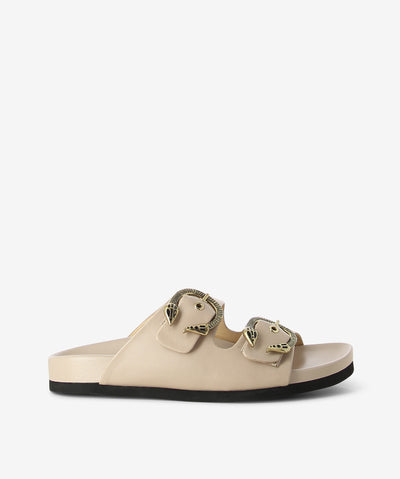 Nude leather slides by Elvio Zanon. It is a slip on style and features snake detail hardware, pin-buckle fastenings, and a soft square toe.