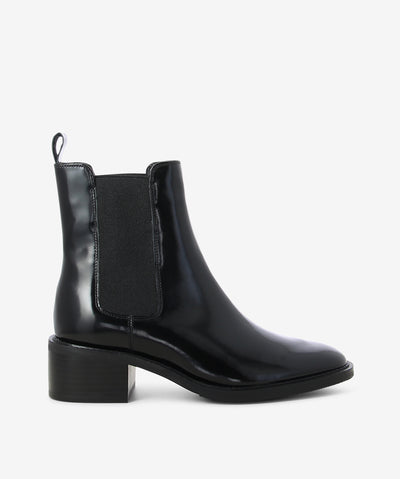 Black hi-shine leather chelsea boots by EOS. It features elasticated side gussets, rear pull tab, and a soft pointed toe.