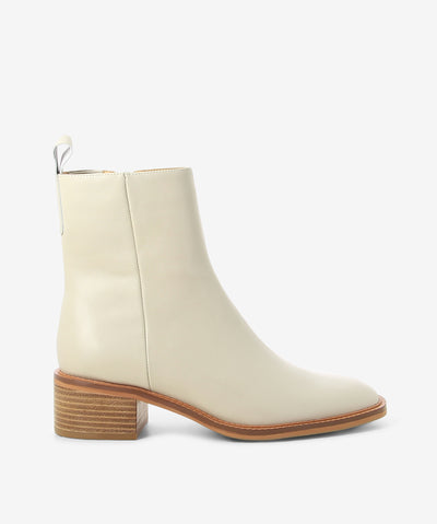 Ivory leather boots by EOS. It features a side zipper closure, rear pull tab, and a soft pointed toe.