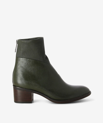 Olive leather ankle boots by Django & Juliette. It features a combination stretch leather upper, rear zip closure, and a round toe.