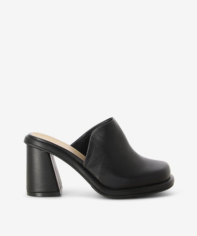 Black leather mules by Epoche Xi. Is a slip-on style and features a side cut detail with a chunky block heel and a soft square toe.