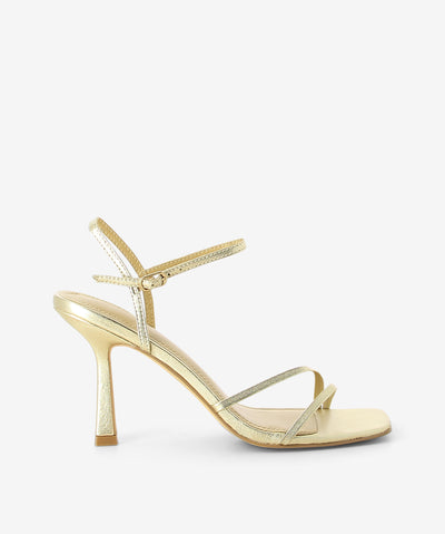 Gold metallic heels by Siren. It features strappy upper, ankle strap with pin-buckle fastening, and a square toe.