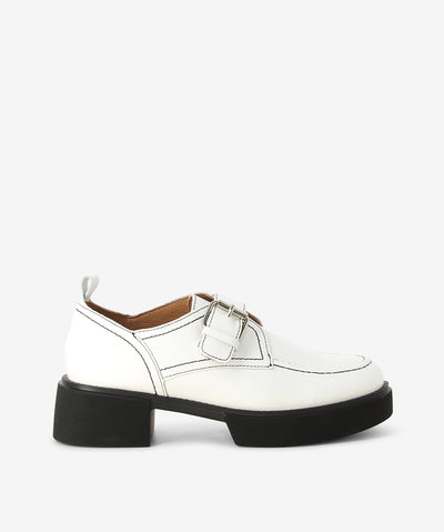 White leather platform loafers by Alfie & Evie. It features front and back platforms, adjustable cross-foot pin-buckle strap, and a soft square toe.