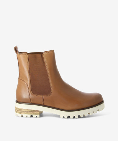 Brown leather chelsea boots by 2 Baia Vista. It features a rear pull tab, chunky cleated sole, and a round toe.