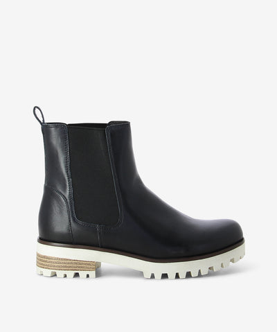 Navy leather chelsea boots by 2 Baia Vista. It features a rear pull tab, chunky cleated sole, and a round toe.