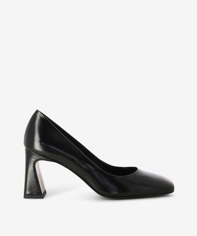 Black leather court shoes by Sempre Di. It is a slip-on style and features a tapered block heel, and a square toe.