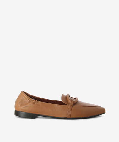 Camel leather loafers by Martini Marco. It is a slip on style and features a low block heel, soft leather cross strap, and a pointed toe.