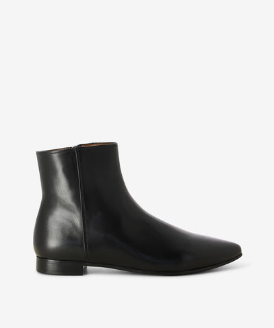 Black leather ankle boots by Martini Marco. It features a side zip closure, low block heel, and a pointed toe.