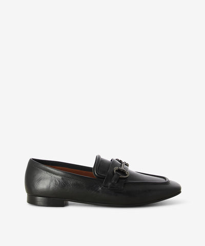 Black leather loafers by Martini Marco. It is a slip on style and features a low block heel, chain embellished cross strap, and a chisel toe.