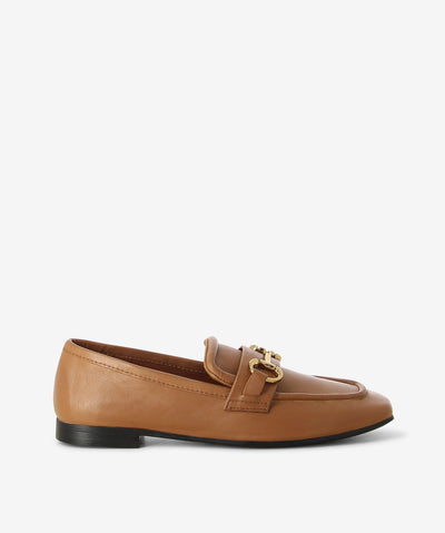 Camel leather loafers by Martini Marco. It is a slip on style and features a low block heel, chain embellished cross strap, and a chisel toe.