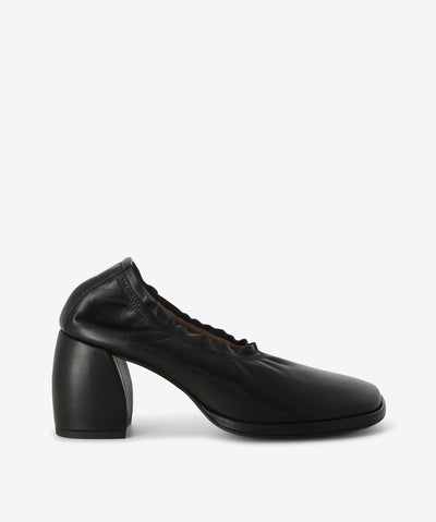 Black leather pumps with a slip-on style and features a ruched elastic collar, block heel and an anatomic square toe.