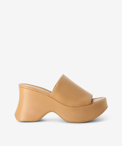 Natural platform sandals featuring a chunky curved sole and a round toe by Jeffrey Campbell.