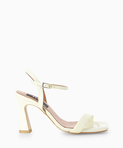 White leather heels with a high shine finish, slender heel and a square toe.