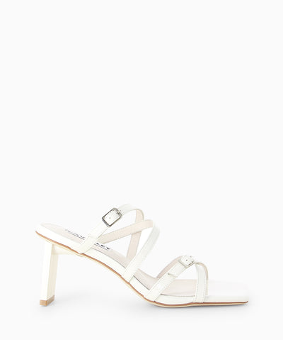 Ivory leather mules featuring a strappy upper with buckle detailing, a slender heel and a square toe.