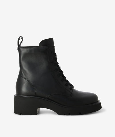 Black leather combat boots with a chunky EVA sole and a round toe by Camper.