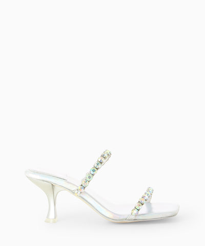 Silver metallic mules with diamanté embellished straps, an hourglass heel and an open square toe.