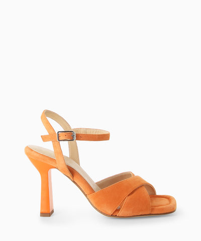 Orange leather heels with a crossover upper, slender heel and an open square toe.
