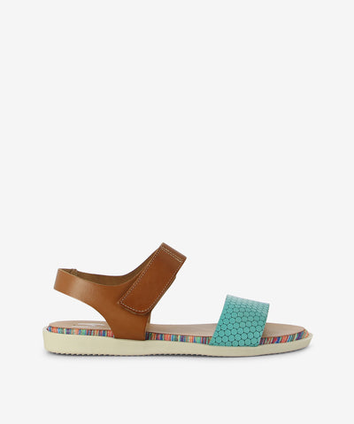 The 1242 Marila Sandal — a playful blend of colour, texture, and Spanish craftsmanship. Featuring aqua front strap with a unique hex pattern, a rounded toe for added comfort, and a smooth brown leather ankle strap, this cheerful style sits on a multi-coloured striped sole that brings joy to every step. Crafted from premium leather for lasting comfort and quality, it features an adjustable velcro ankle strap, a lightweight sole with striped detailing, and a low heel for easy, all-day wear.