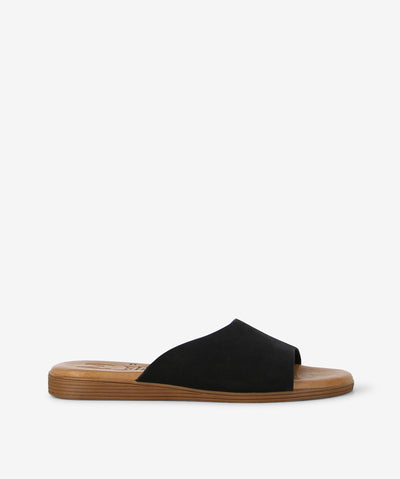 Step into effortless style with the Marilla 1423 slide — a simple yet striking design made in Spain with care. This easy slide features a wide textured black strap that adds a cool, modern touch to any outfit. Designed with a soft blue front strap with subtle texture, a smooth brown sole for everyday comfort, a round toe for a relaxed fit, and a flat profile for easy wear all day long.