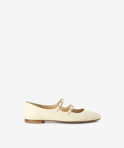 White patent mary-jane flats by Fabio Rusconi. It features 2 thin buckle straps, a low stacked heel, and a soft pointed toe.