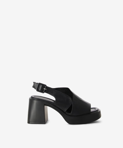 Black leather heeled sandals by Sempre Di by S Sempre Di. It has a slingback strap with asymmetric design and features a platform midsole, block heel, and a soft square toe.