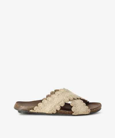 Cream crossed sandals by Sempre Di. It is a slip-on style with woven raffia upper, a cork finish footbed and a round toe.