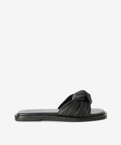 Black leather slides by Inuovo. Is a slip-on style and features twisted leather straps, a low heel and a soft square toe. 