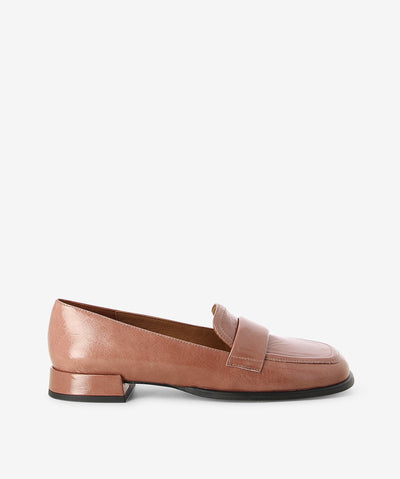 Soft pink crinkle patent loafers by Neo. It is a slip on style and features a low block heel, padded upper strap, and a soft square toe.