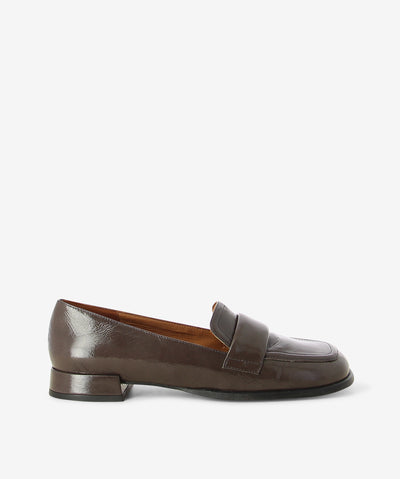 Dark brown crinkle patent loafers by Neo. It is a slip on style and features a low block heel, padded upper strap, and a soft square toe.