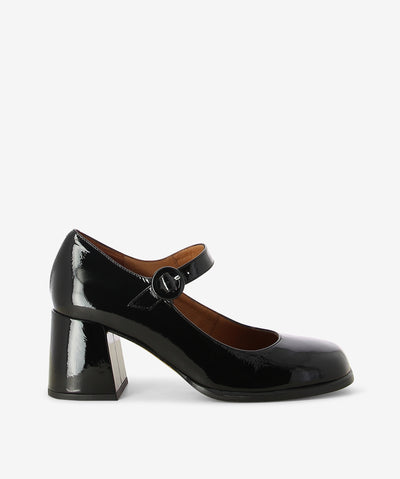 Black crinkle patent leather Mary Jane heels by Neo. It features a block heel, adjustable pin-buckle strap, and a soft square toe.