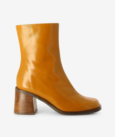 Tan leather ankle boots by Neo. It features a block heel, side zip closure, and a soft square toe.