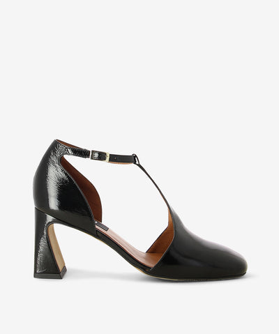 Black crinkle patent leather heels by Neo. It features a tapered block heel, T-bar strap with an adjustable pin-buckle strap, and a round toe.