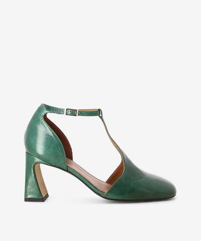 Green crinkle patent leather heels by Neo. It features a tapered block heel, T-bar strap with an adjustable pin-buckle strap, and a round toe.