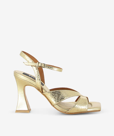 Gold snake embossed metallic leather heels by Neo. It features embossed cross front straps, adjustable pin-buckle ankle strap, and a square toe.