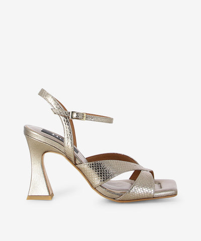 Stone snake embossed metallic leather heels by Neo. It features embossed cross front straps, adjustable pin-buckle ankle strap, and a square toe.