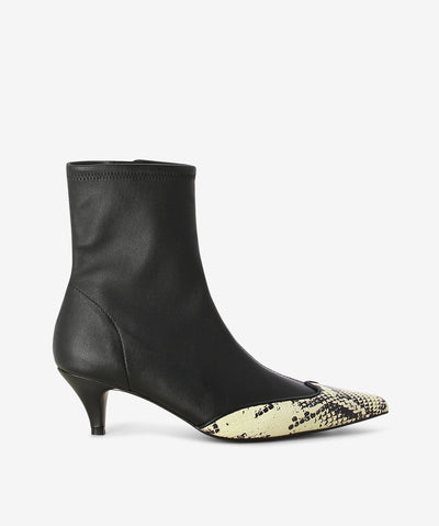 Black and snake print leather ankle boots by Caverley. It features a kitten heel, side zip closure, and a pointed toe.