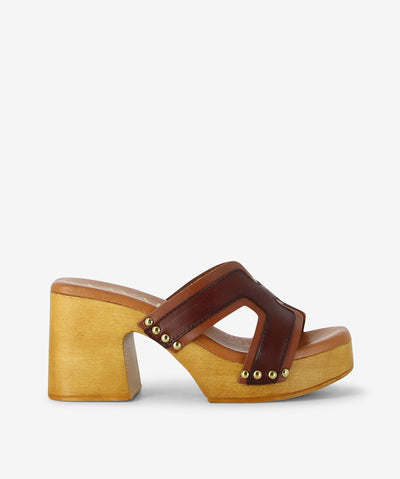 Bold, sculptural, and effortlessly earthy—the Ari Caoba Combo sandal by Vayah blends retro charm with a handcrafted twist. Leather straps in a striking combo pattern meet a chunky wooden heel feel for a standout style made for those who walk with intention.
• Textured leather straps: Combo-patterned design adds movement and visual interest
• Wooden feel platform &amp; heel: Smooth medium-toned wood for natural lift and vintage structure
• Gold rivet accents: Subtle shine where leather meets wood