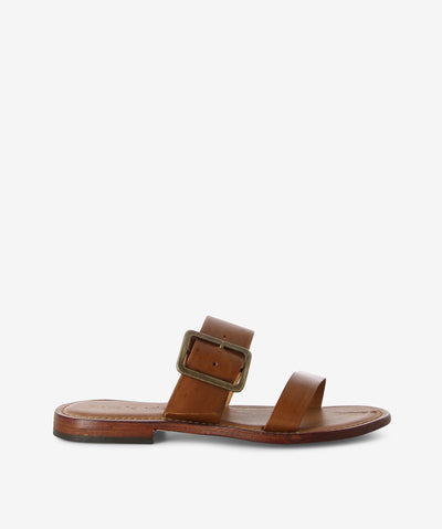 Brown leather slides with a slip-on style and features two straps with a chunky buckle, a low stacked heel and a round toe.