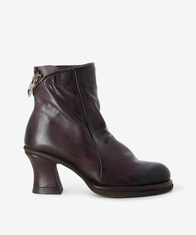 Wine leather boots by Sempre Di by A.S.9.8. It features a wrap around zipper fastening with am extended facing, tapered heel, and a round toe.