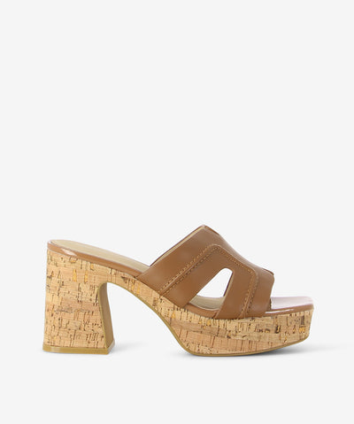 Tan leather and cork heels by 2 Baia Vista. It features a cork heel and platform, tan stitched upper, and a square toe.