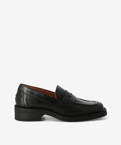 Black leather loafers by ZOMP. It is a slip-on style and features patent leather with a low heel and a square toe.