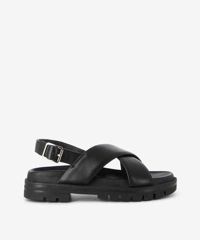 Black leather sandals by 2 Baia Vista. It has a slingback fastening and features crossover straps, a chunky tread sole and a round toe.